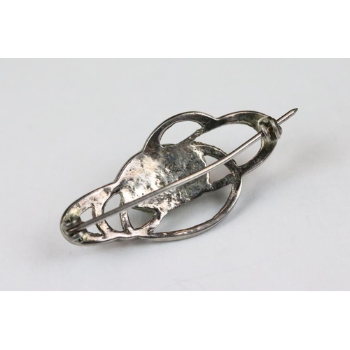 271 - A ladies hallmarked sterling silver celtic pattern brooch with cabochon centre.