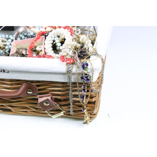 320 - A collection of vintage and contemporary costume jewellery contained within a wicker basket.