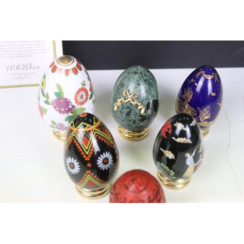 326 - A collection of ornamental eggs to include polished stone and cut glass examples.