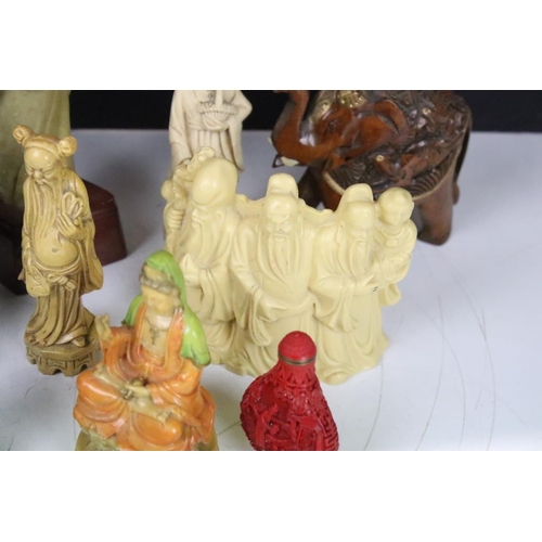 327 - A group of oriental collectables to include carved ornamental fugures, snuff bottle and cast metal f... 