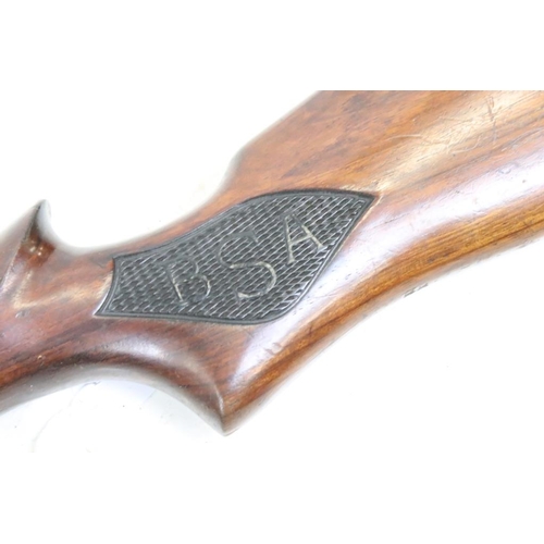 318 - A vintage B.S.A. air rifle, BSA logo carved to the polished wooden, overall length approx 110cm.