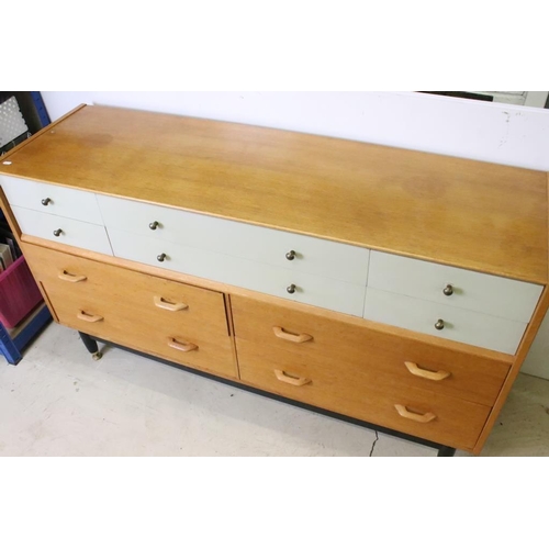 567 - Mid century Retro E. Gomme G-Plan ' Brandon ' Golden Oak and White Sideboard or Chest with an arrang... 