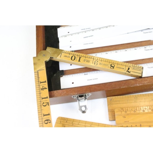 356 - A collection of vintage boxwood rulers to include Rabone folding examples together with a surveyors ... 