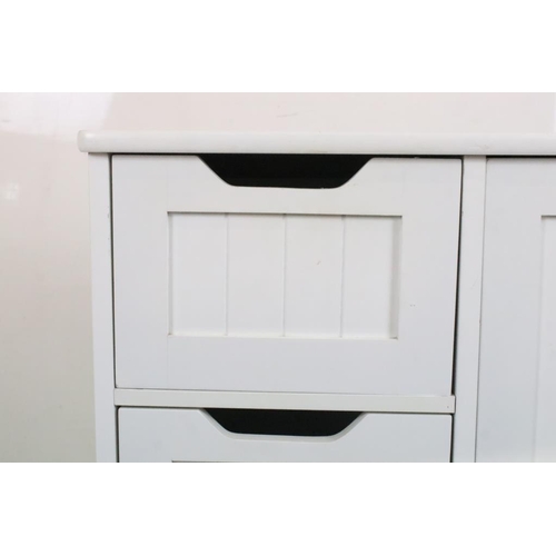 609 - Pair of White Cabinets, each with four short drawers and a cupboard door, each 56cm wide x 30cm deep... 