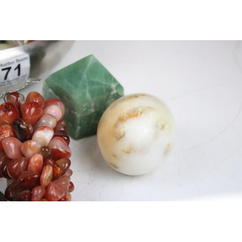 371 - A collection of polished stone eggs and bunches of grapes together with a selection of polished mine... 