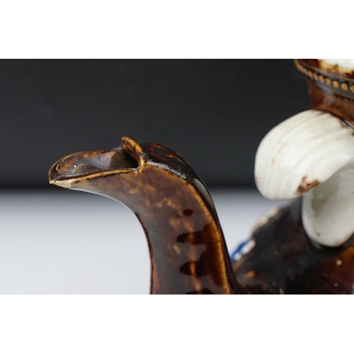 104 - 19th Century Measham pottery bargeware teapot & cover, having typical moulded floral motifs on a bro... 