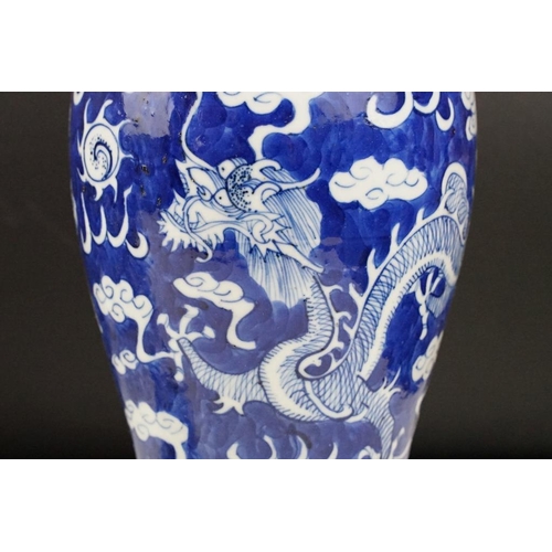 105 - Pair of Chinese blue & white baluster vases and covers, decorated with dragons chasing a flaming pea... 