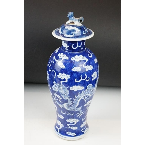 105 - Pair of Chinese blue & white baluster vases and covers, decorated with dragons chasing a flaming pea... 