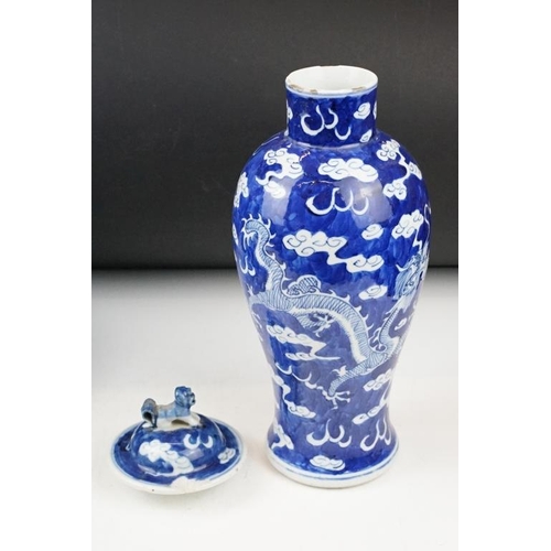 105 - Pair of Chinese blue & white baluster vases and covers, decorated with dragons chasing a flaming pea... 