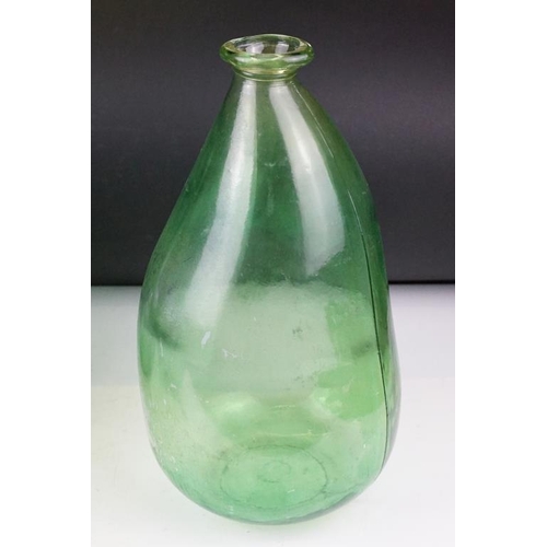 37 - Three green glass bottles / carboys to include a pair of bulbous form (with stoppers) and a further ... 