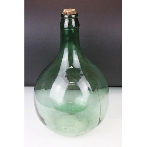 37 - Three green glass bottles / carboys to include a pair of bulbous form (with stoppers) and a further ... 