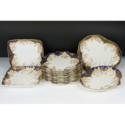 53 - Royal Doulton dessert service with gilt foliate decoration & cobalt blue borders, to include 12 dess... 