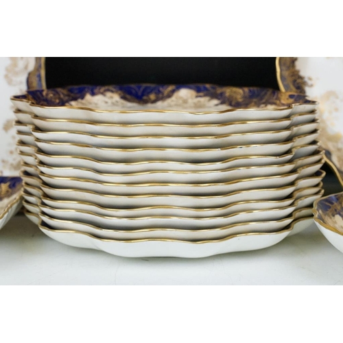 53 - Royal Doulton dessert service with gilt foliate decoration & cobalt blue borders, to include 12 dess... 