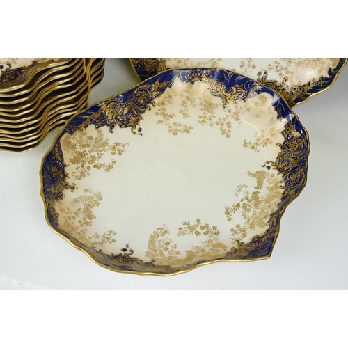 53 - Royal Doulton dessert service with gilt foliate decoration & cobalt blue borders, to include 12 dess... 