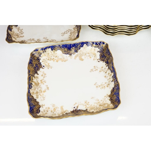 53 - Royal Doulton dessert service with gilt foliate decoration & cobalt blue borders, to include 12 dess... 