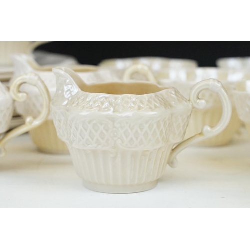 54 - Belleek Cream Cob Lustre tea ware, first and second period, to include 8 cups, 12 saucers, 3 milk ju... 