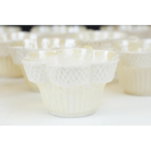 54 - Belleek Cream Cob Lustre tea ware, first and second period, to include 8 cups, 12 saucers, 3 milk ju... 