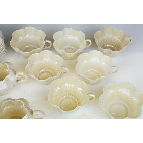 54 - Belleek Cream Cob Lustre tea ware, first and second period, to include 8 cups, 12 saucers, 3 milk ju... 