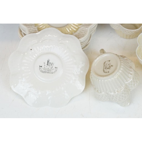 54 - Belleek Cream Cob Lustre tea ware, first and second period, to include 8 cups, 12 saucers, 3 milk ju... 