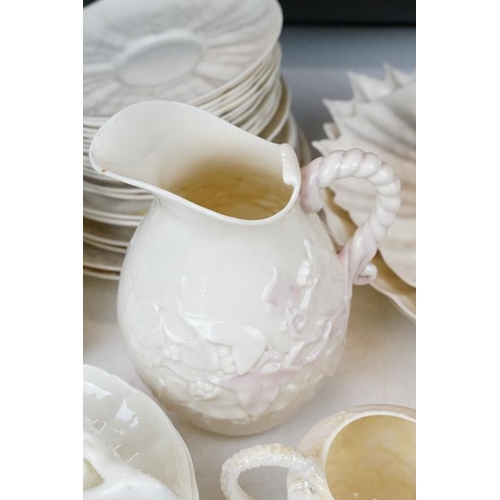 65 - Collection of Belleek moulded cream ceramics, 1st & 2nd period, to include a reticulated basket, 31 ... 