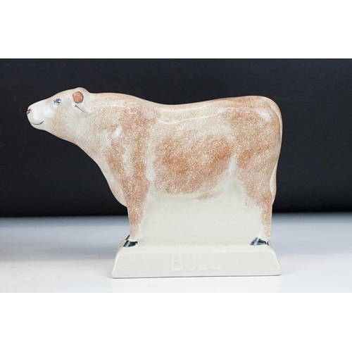 94 - Three Rye Pottery animal figures to include 'Champion' pig (11cm high), Cow and Bull; plus a similar... 