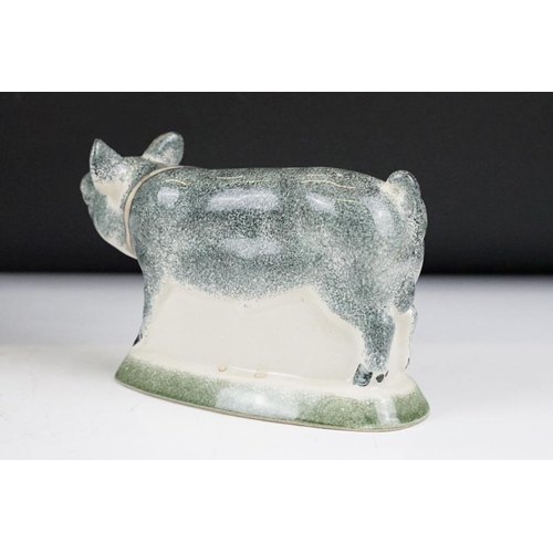 94 - Three Rye Pottery animal figures to include 'Champion' pig (11cm high), Cow and Bull; plus a similar... 