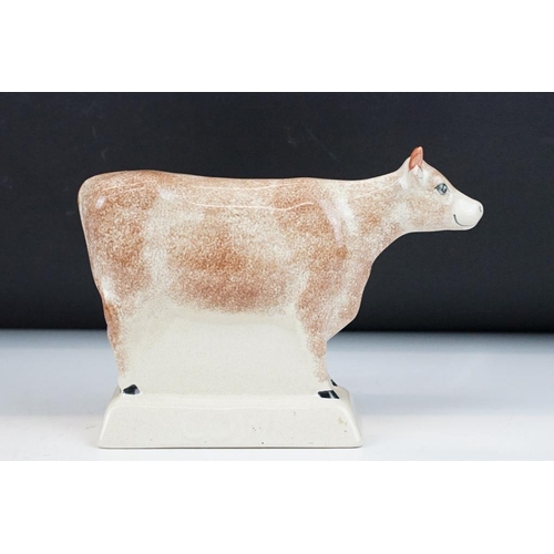 94 - Three Rye Pottery animal figures to include 'Champion' pig (11cm high), Cow and Bull; plus a similar... 