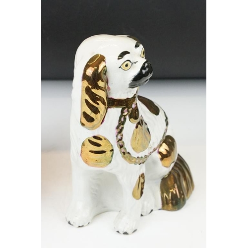 98 - Pair of 19th Century Staffordshire Pottery seated mantle dogs with gilt details, approx 22cm high