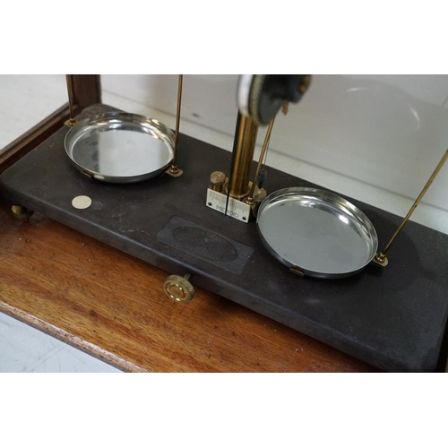 398 - Set of 20th Century Griffin & Tatlock brass balance scales, housed within a glazed wooden case. Appr... 