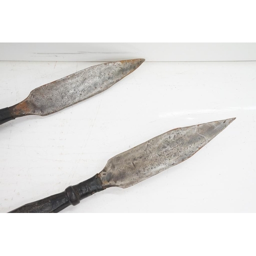 163 - Pair of African wooden tribal spears, with leather handholds and engraved decoration to metal tips, ... 