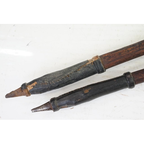 163 - Pair of African wooden tribal spears, with leather handholds and engraved decoration to metal tips, ... 