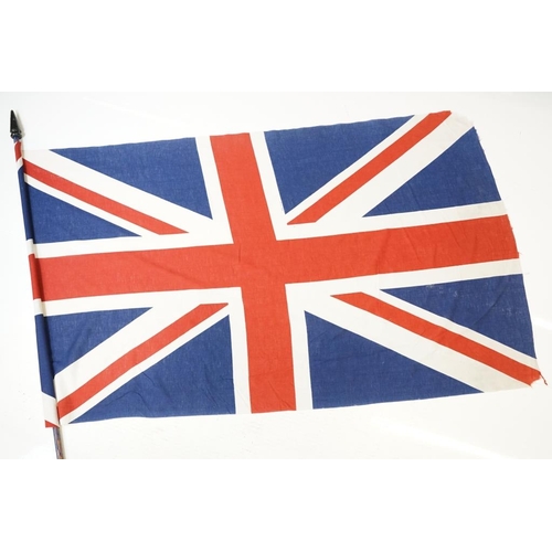 165 - Two large flags on poles to include a vintage Union Jack cloth flag and a French tricolour example. ... 