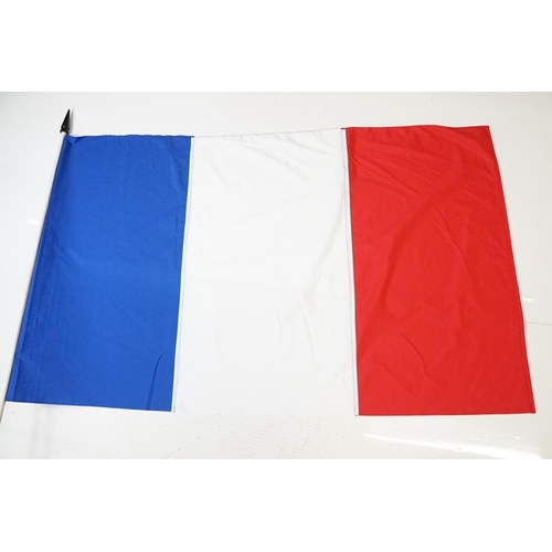 165 - Two large flags on poles to include a vintage Union Jack cloth flag and a French tricolour example. ... 