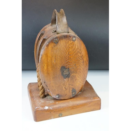 167 - Oak ships pulley block with twin rollers, raised on a rectangular base, approx 34cm high