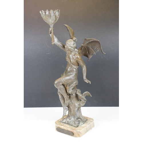 171 - Bronze lamp base in the form of a lady with batwings holding a torch aloft, raised on a marble base ... 