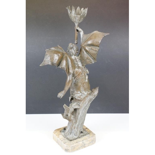 171 - Bronze lamp base in the form of a lady with batwings holding a torch aloft, raised on a marble base ... 