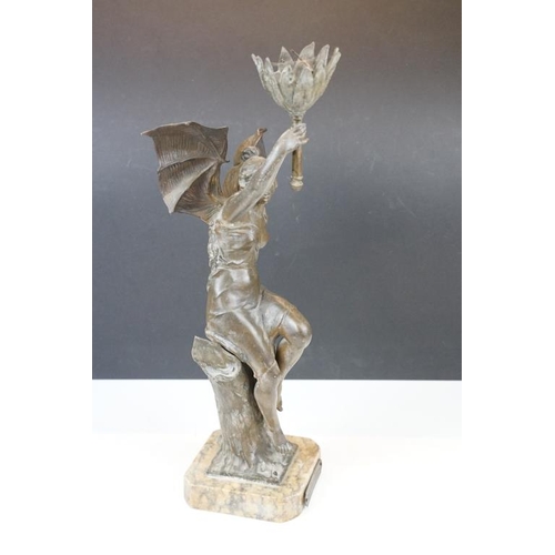 171 - Bronze lamp base in the form of a lady with batwings holding a torch aloft, raised on a marble base ... 