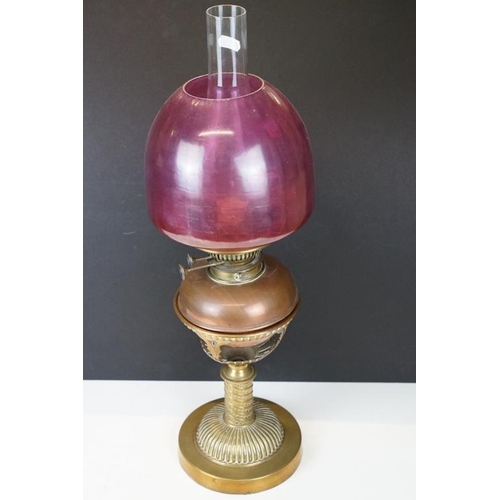 172 - Late 19th / early 20th century brass & copper oil lamp with ruby glass shade and copper font, raised... 