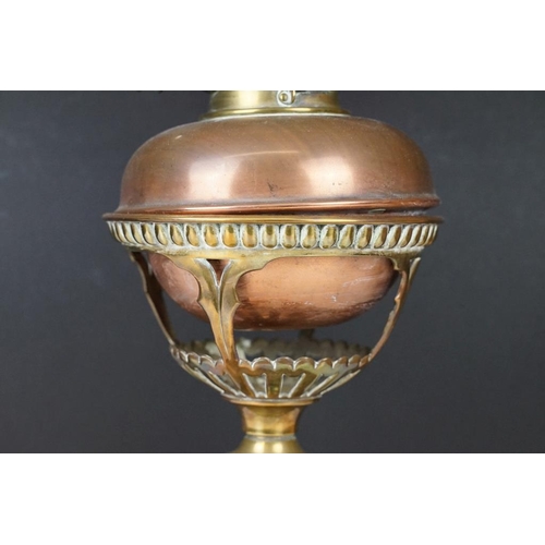 172 - Late 19th / early 20th century brass & copper oil lamp with ruby glass shade and copper font, raised... 