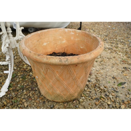 541 - Cast metal painted patio table (approx 70cm high), together with a terracotta plant pot with lattice... 