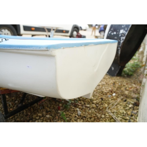 542A - Fibreglass rowing boat in pale blue, with white hull, two sets of oars, three life jackets and road ... 