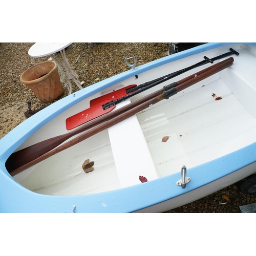 542A - Fibreglass rowing boat in pale blue, with white hull, two sets of oars, three life jackets and road ... 