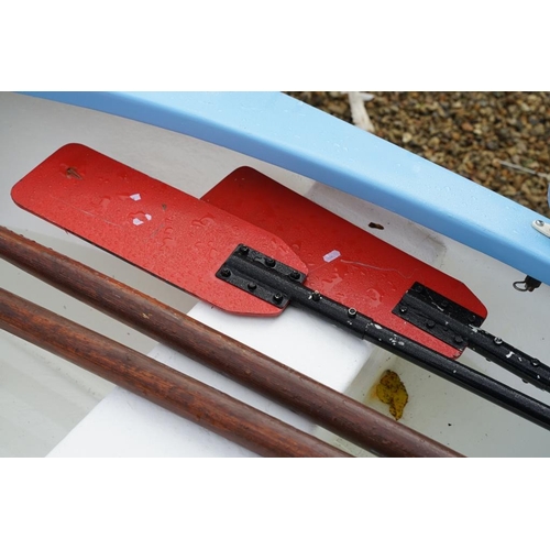 542A - Fibreglass rowing boat in pale blue, with white hull, two sets of oars, three life jackets and road ... 