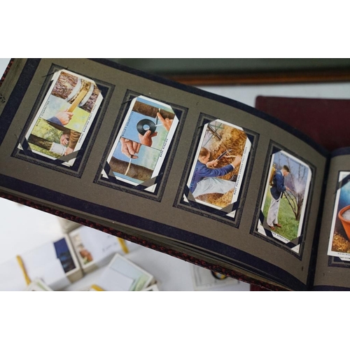 392 - Collection of cigarette cards, to include two albums, framed & loose examples, featuring Players Cri... 