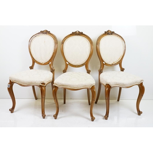 569 - Set of Six French style Dining Chairs with carved walnut frames, upholstered oval backs and stuff ov... 