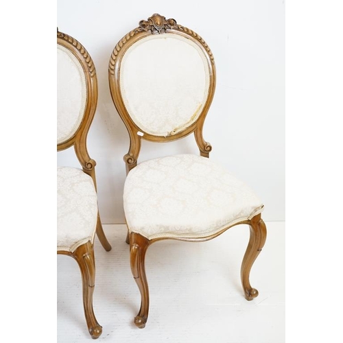 569 - Set of Six French style Dining Chairs with carved walnut frames, upholstered oval backs and stuff ov... 