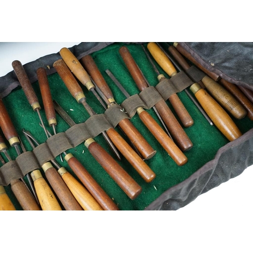 404 - Collection of 39 vintage woodworking chisels, wooden handled, contained within a roll-up case