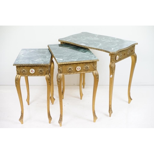 600 - Nest of Three French style Tables with faux marble tops of serpentine form and gilt coloured legs, s... 