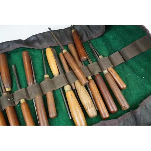 404 - Collection of 39 vintage woodworking chisels, wooden handled, contained within a roll-up case