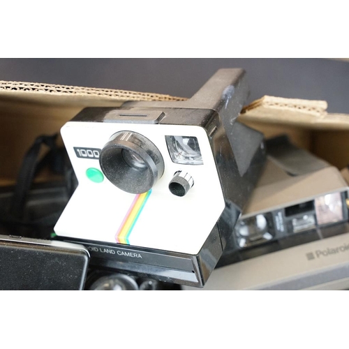 409 - A large collection of Polaroid Instant cameras to include a Polaroid 600, Impulse and various SX-70 ... 